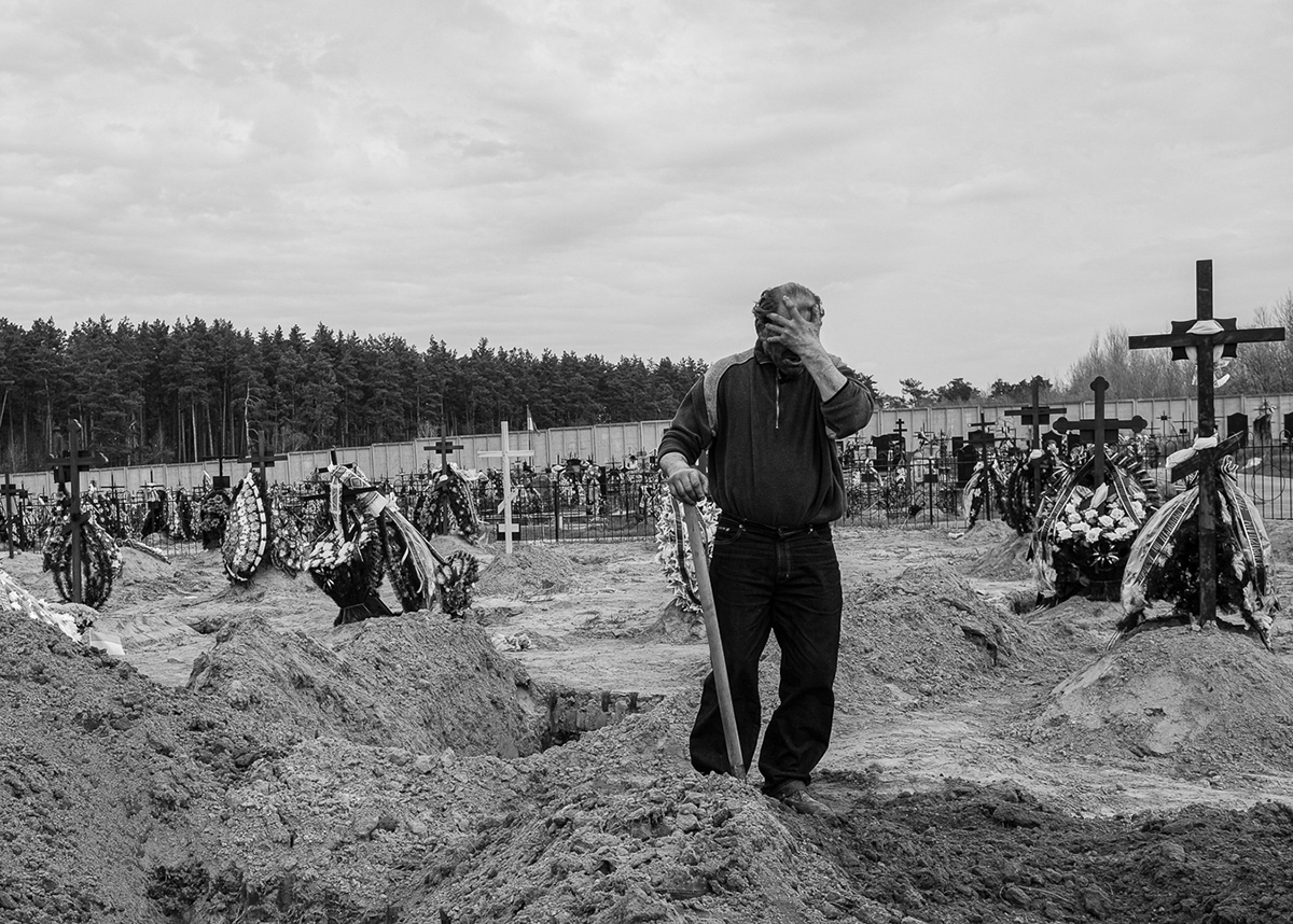 A gravedigger in Bucha preemptively digs for new arrivals. April, 2022.